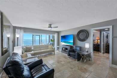 Living room with stone tile flooring, a brick fire