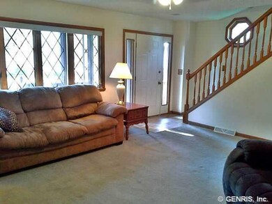 Living Room. The open staircase keeps the open fee