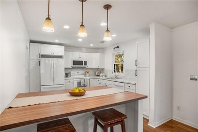 Kitchen featuring white cabinetry, white appliance