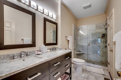 Full bath with a sink, a marble finish shower, toi