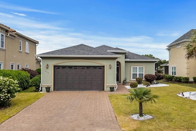 Single story home featuring decorative driveway, a