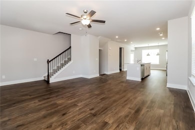 Unfurnished living room with dark wood-style floor