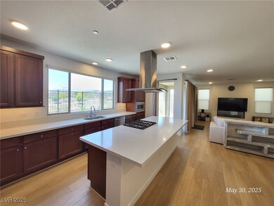 Kitchen featuring island exhaust hood, a sink, app