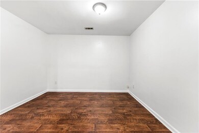 Empty room featuring baseboards and wood finished floors