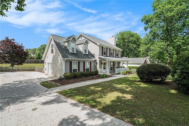 View of front of home featuring a chimney, drivewa