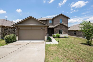 Traditional home with brick siding, driveway, a g
