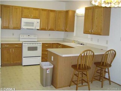 Open kitchen/dining area showing breakfast bar and