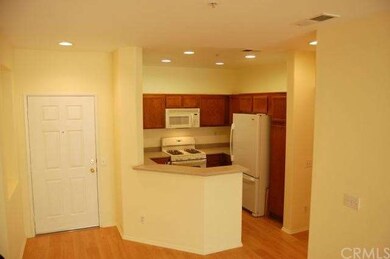 View Of Kitchen From Great Room.  Recessed Lights Add A Nice Designer Touch.  Breakfast Counter For Quick Meals.  Refrigerator Is Included.