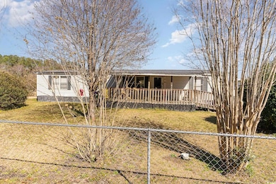 Single story home with a front yard and fence priv