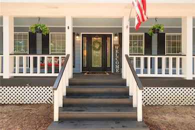 View of exterior entry with a porch