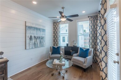 A dedicated sitting area offers the perfect space to unwind, read, or enjoy a quiet morning coffee.  This photo is of the Chamberlain model and does not represent this homesite.
