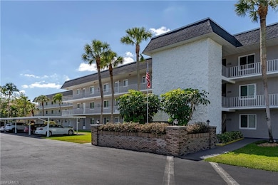 View of property featuring covered parking