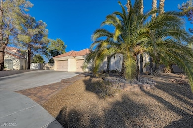 View of front of home with driveway, an attached garage, a tiled roof, and stucco siding