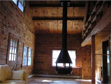 Great Room. Suspended wood-burning...