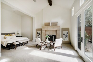 Impressive primary bedroom with soaring ceilings,