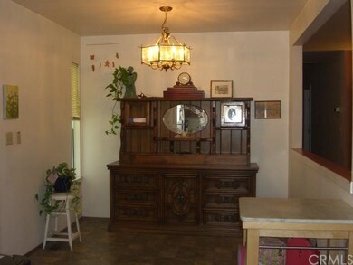 Dining area off kitchen with chandelier and open p