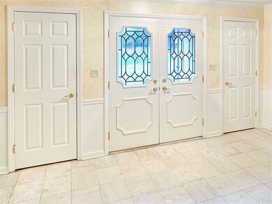 Foyer with dual guest coat closets.