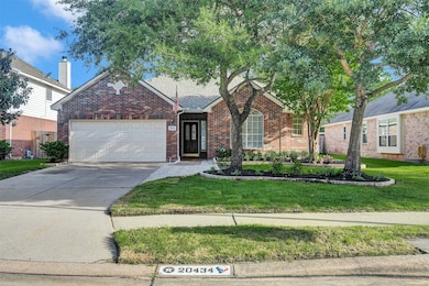 Charming front yard featuring lush greenery, matur