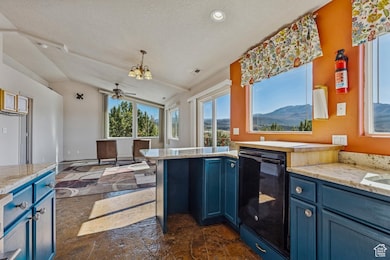 Kitchen with blue cabinets, light stone counters, black dishwasher, lofted ceiling, and a peninsula