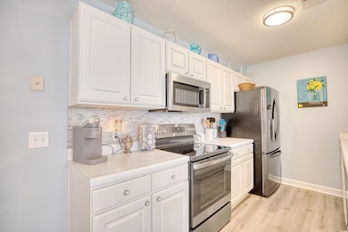 Kitchen featuring light wood-style flooring, appli