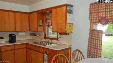 It looks out onto the pretty fenced yard.