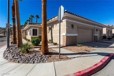 View of front of home with a tile roof, stucco siding, driveway, and a garage