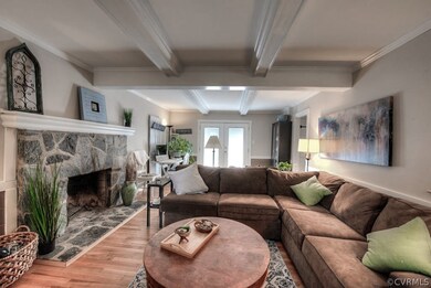 Beamed ceilings and a gorgeous stone fireplace lend a stately air