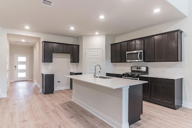 Kitchen with stainless steel appliances, a sink, 