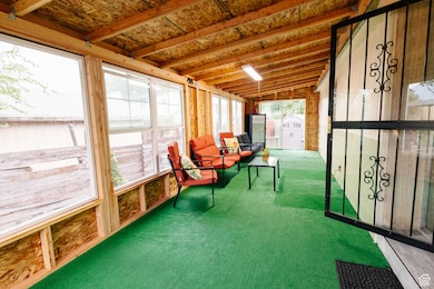Sunroom / solarium featuring vaulted ceiling