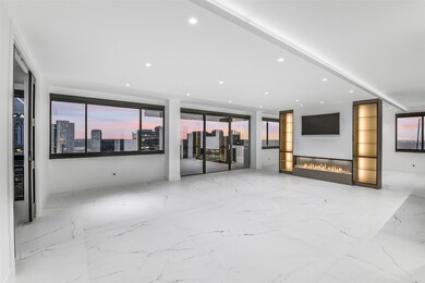 From the moment you enter, the sense of space and light is unmistakable. The foyer unfolds into a grand open living area where panoramic city views steal the show. Crisp, modern design and refined finishes create a seamless transition from the entry to the main living spaces—perfect for both everyday living and elegant entertaining.