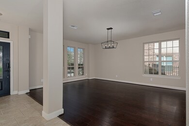 The formal dining/living room has wood flooring an