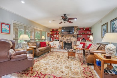 Living area with ornamental molding, a ceiling fan