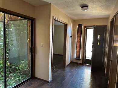 Foyer featuring a textured ceiling, a healthy amou