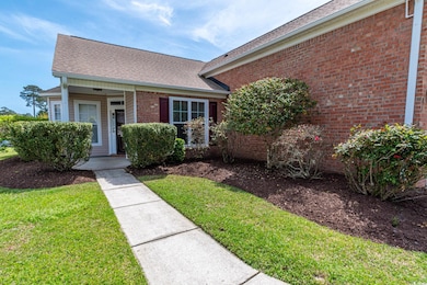 Single story home featuring a front yard, brick si
