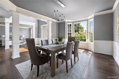 Dining space featuring crown molding and light har