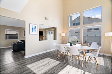 Dining space with a towering ceiling, visible vent
