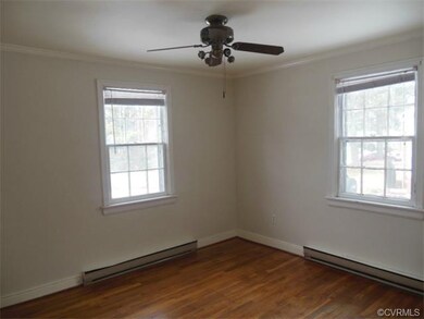 The master bedroom has beautiful wood floors, plenty of natural lighting, and crown molding.
