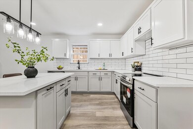 Kitchen featuring decorative backsplash, stainless