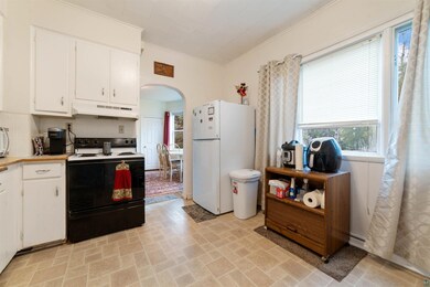 Kitchen with white appliances, white cabinets, and