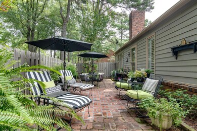 Lush greenery accent a great double brick patio fo