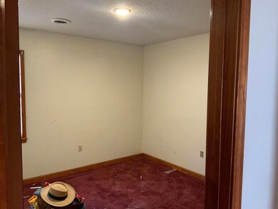 Bedroom with a textured ceiling and carpet floors