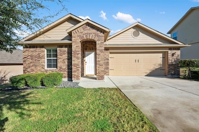 Single story home featuring concrete driveway, brick siding, a front lawn, and an attached garage