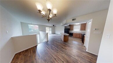 Kitchen featuring a sink, open floor plan, dark w