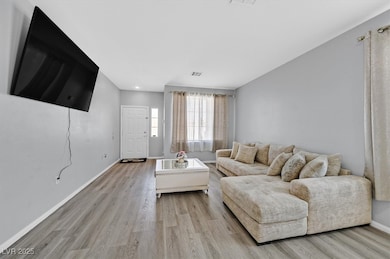 Living room featuring baseboards and light wood-style floors