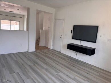 Unfurnished living room with visible vents, basebo