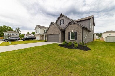 Craftsman inspired home with brick siding and concrete driveway
