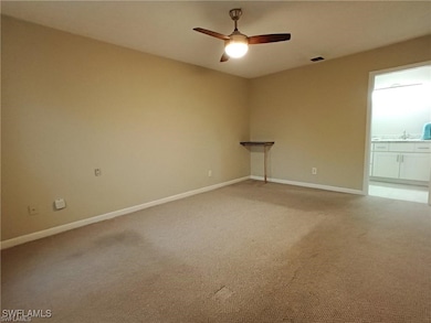 Spare room featuring a ceiling fan, baseboards, an