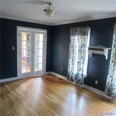 Formal living room with French doors, hardwood flo