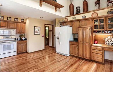 Kitchen with hardwood floors and storage galore! T