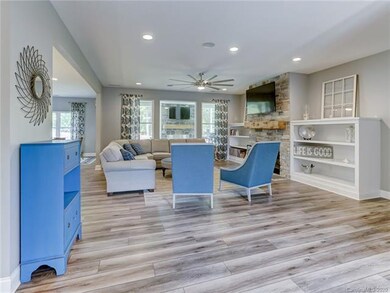 Great Room with stone, wood-burning fireplace and 